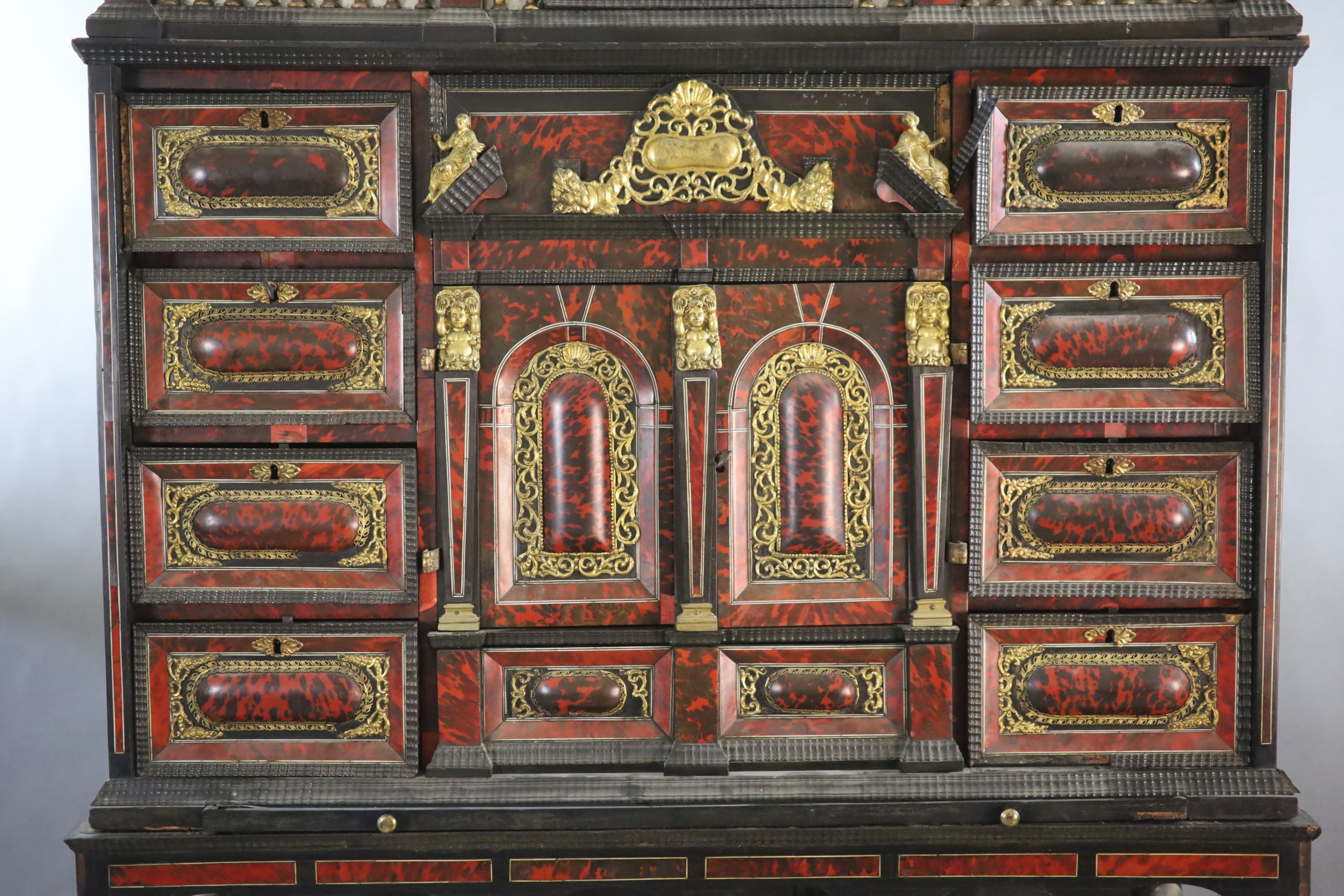 A late 17th century Portuguese ormolu mounted ebony and red tortoiseshell cabinet on stand, W.124cm D.46cm H.187cm